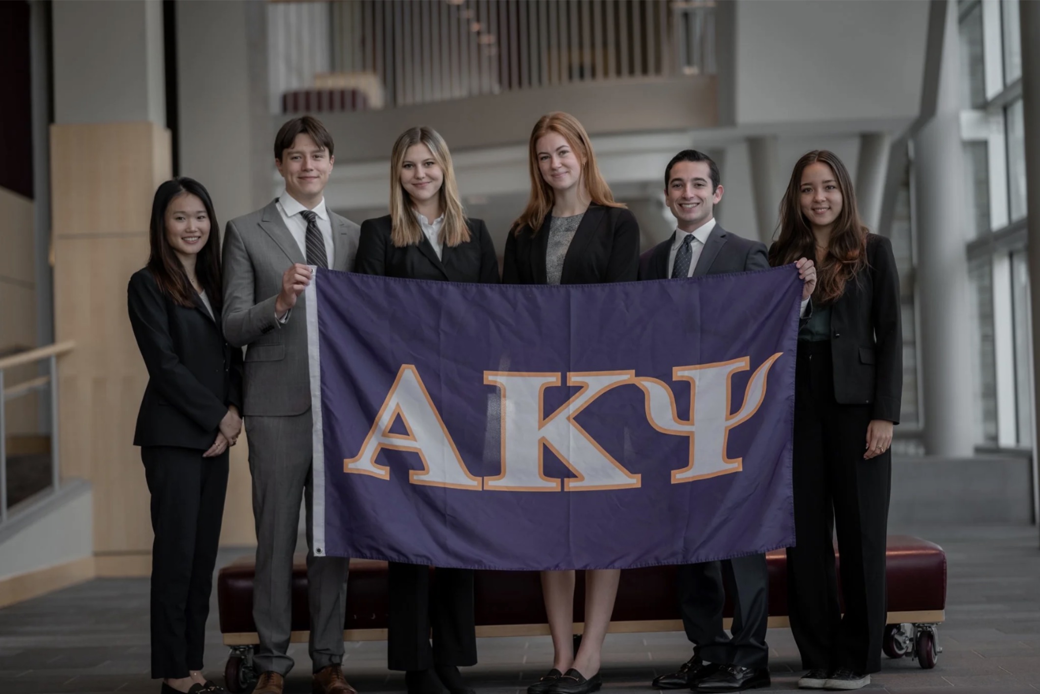 Brothers holding the AKPsi flag